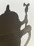 Shadow of the old beer stein with pewter lid on a light background