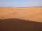 A shadow ot two people on the Great Dune of Merzouga in the Erg Chebbi desert in the African Sahara, Morocco