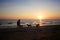 Shadow people and dogs at sunset along the beach