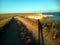 Shadow people on a sunset steppe and sea