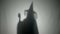 Shadow silhouette of an evil witch dialing a phone number laughing and cursing on the phone on Halloween day -