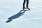 Shadow of a skateboarder on asphalt. Blue toning