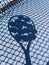 Shadow of tennis balls on the racket on hard court by the net. Tennis net shadows on tennis yellow balls.