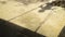 Shadow of unrecognizable boy child on a swing seat in summer afternoon.