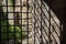 Shadow of wired fence on old brick wall