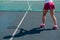 Shadow of woman tennis player. Close-up of female legs on an outdoor tennis court.