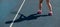 Shadow of woman tennis player. Close-up of female legs on an outdoor tennis court.