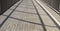 Shadows of the bannister of a footbridge