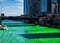 Shadows of buildings cast along the Chicago River which is dyed green for St. Patrick`s day