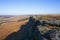 Shadows fall across the gritstone face of Stanage Edge