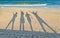 Shadows of four people against the background of the sea and sky