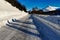 Shadows of several photographers on snowy road in winter mountains