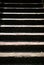 Shadows on stairs create alternating rows of light and dark.