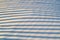 Shadows with stripes on the snow cover