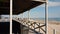 Shady boardwalk overlooking a scenic seascape on the East Hampton Main Beach