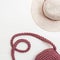 Shady hat and handbag of pink color on light background