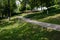 Shady hillside footpath in woods on sunny summer day