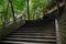 Shady hillside stone steps with balustrade before ancient Chines