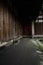 Shady lichen-covered path under eaves of ancient Chinese wooden