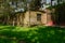 Shady path in grassy lawn outside ancient house in sunny summer a