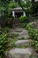 Shady stone stairway to hilltop aged Chinese building