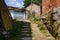 Shady stone steps to street in aged houses on sunny summer day