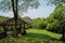 Shady wooden gazebo at sunny spring noon