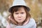 Shaggy girl in jacket, gray scarf and fedora hat