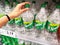 SHAH ALAM, MALAYSIA - 18 September 2020 : Hand pick up a Sprite soda soft drink bottle on the supermarket shelf.