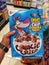 SHAH ALAM,MALAYSIA-22 June 2022 : Hand hold a new box of COOKIE CRISP breakfast cereal for sell in the supermarket