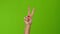 Shaking girl hand gesture denoting the peace. Green screen studio