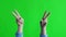 Shaking girl hands gesture denoting the peace. Green screen studio