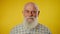 Shaking head. Portrait of an elderly gray bearded man in a shirt who turns his head from side to side and smiles