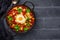 Shakshouka - dish of eggs poached in a sauce of tomatoes, olive oil, peppers, onion and garlic