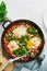 Shakshouka, eggs poached in sauce of tomatoes, olive oil. Mediterranean cousine