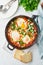 Shakshouka, eggs poached in sauce of tomatoes, olive oil. Mediterranean cousine