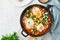 Shakshouka, eggs poached in sauce of tomatoes, olive oil. Mediterranean cousine