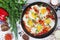 Shakshouka with five cooked eggs on top of tomato sauce in cast iron skillet