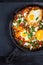 Shakshouka - Middle eastern traditional dish with poached eggs in tomato sauce