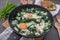 Shakshouka - Middle eastern traditional dish with poached eggs and wild garlic