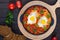 Shakshuka - a dish of eggs fried in a sauce of tomatoes, hot pepper, onions and seasonings.