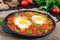 Shakshuka - a dish of eggs fried in a sauce of tomatoes, hot pepper, onions and seasonings.