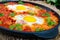 Shakshuka - a dish of eggs fried in a sauce of tomatoes, hot pepper, onions and seasonings