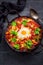 Shakshuka -  dish of eggs poached in a tomato sauce with Feta cheese and coriander