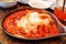 Shakshuka with eggs and tomato in a cast iron pan