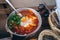 Shakshuka, Fried Eggs in Tomato Sauce on the Table