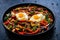 Shakshuka - fried eggs with vegetables on black wooden table