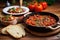 shakshuka with garlic bread on the side on a wooden kitchen island