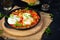 Shakshuka with grilled bread. Fried eggs with tomato, pepper, garlic and herbs