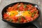 Shakshuka in iron frying pan on wood. Typical food in Israel.